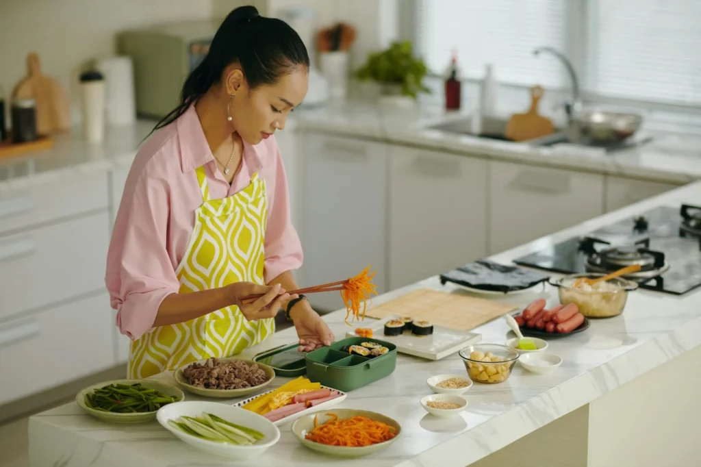 Housewife Putting Food In Lunchbox